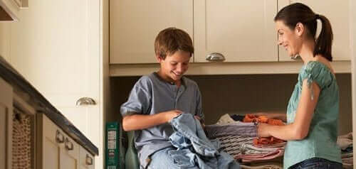 dreng der hjælper sin mor med vasketøj