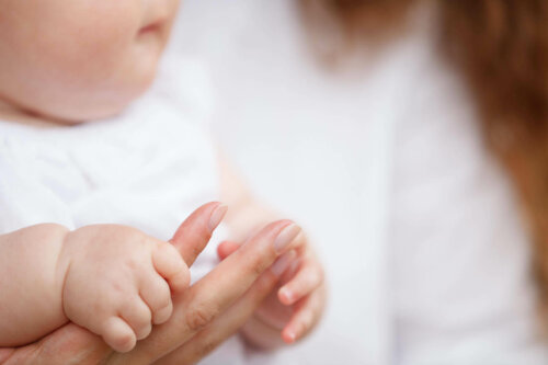 baby der holder om mors hånd