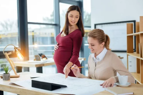 Kvinde på kontor har valgt at arbejde under graviditet